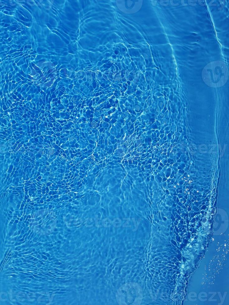 Defocus blurred blue water shining in the sea. rippled water detail background. The water surface in the sea, ocean background. Water wave under sea texture background. photo