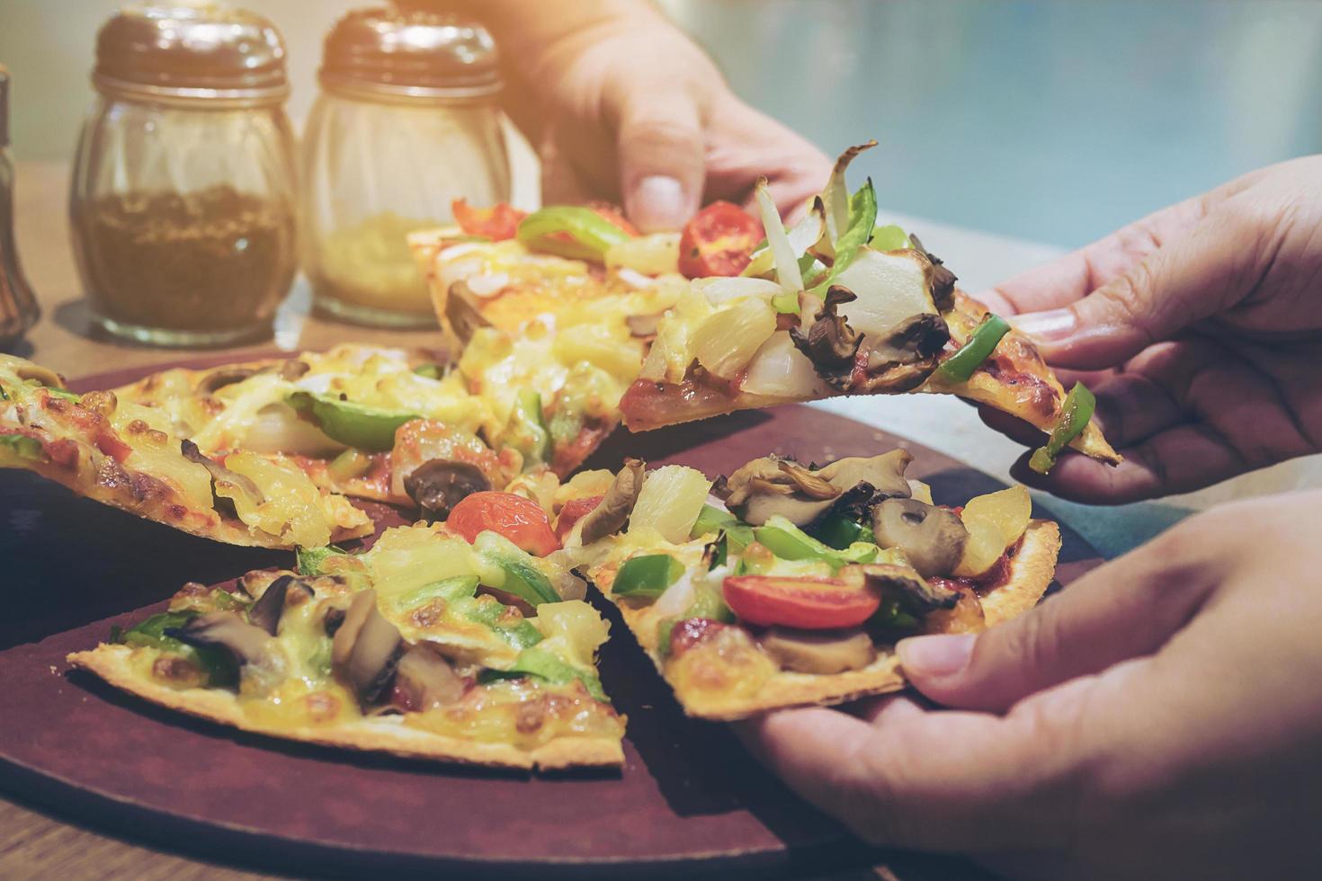 Vintage photo of pizza with colorful vegetable topping ready to be eaten