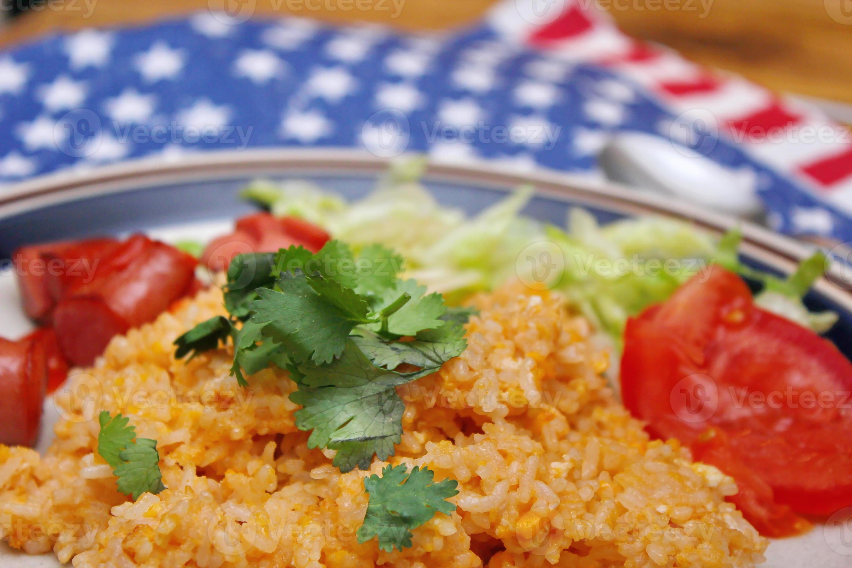 Fried rice with fried sausage served in a creamy dish with tomatoes and