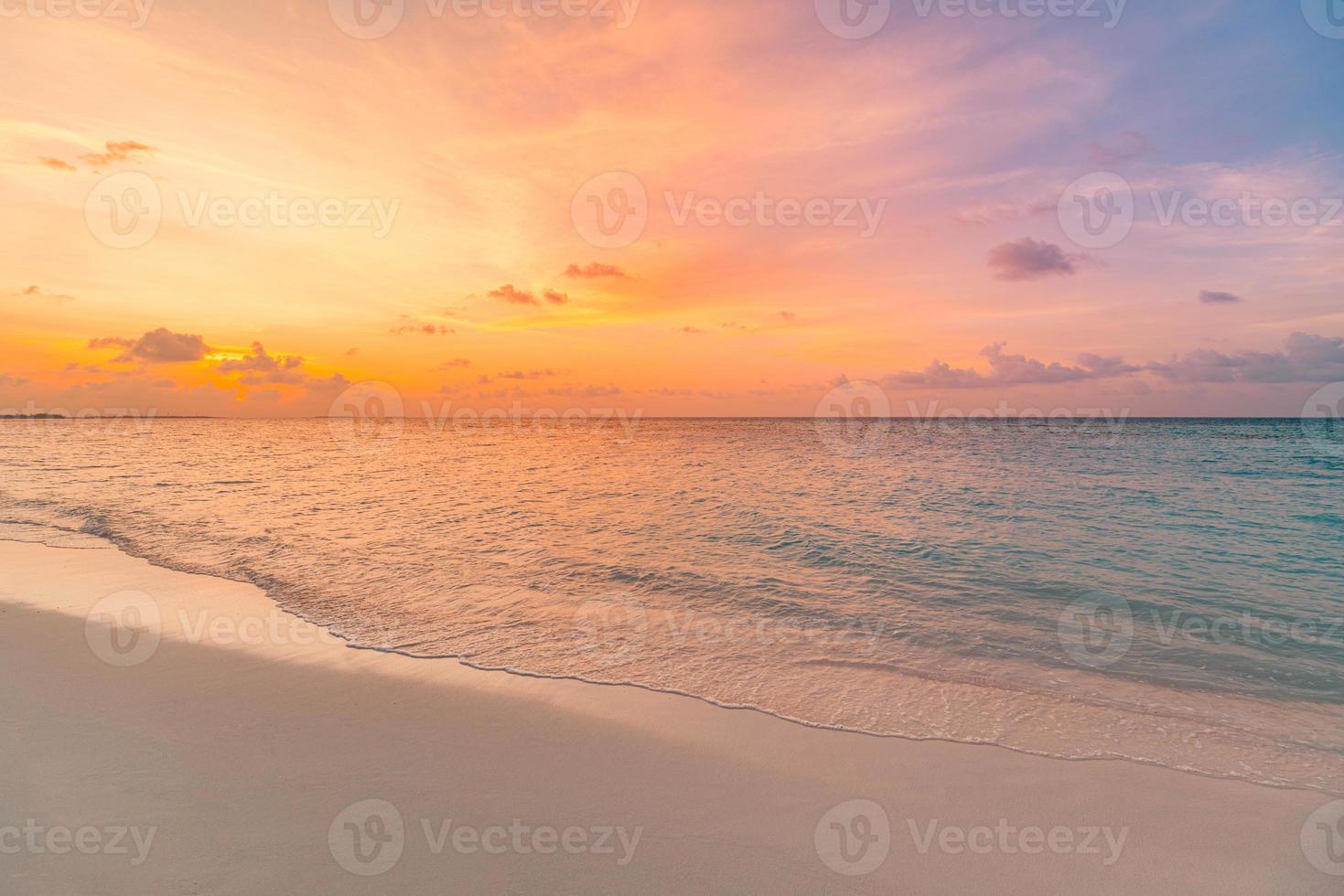 Closeup sea sand beach. Panoramic beach landscape. Inspire tropical beach seascape horizon. Orange and golden sunset sky calmness tranquil relaxing sunlight summer mood. Vacation travel holiday banner photo