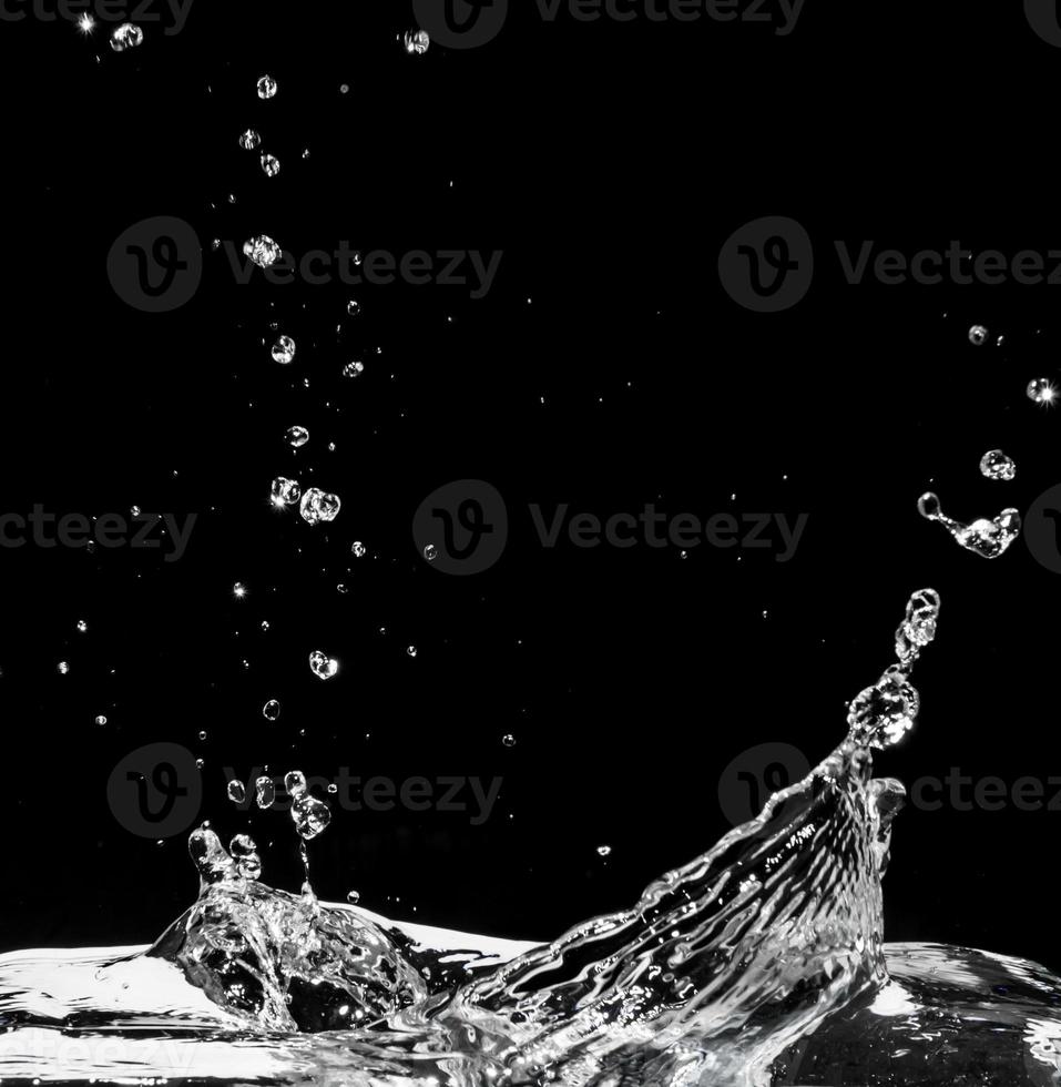 Water splash isolated on black background photo