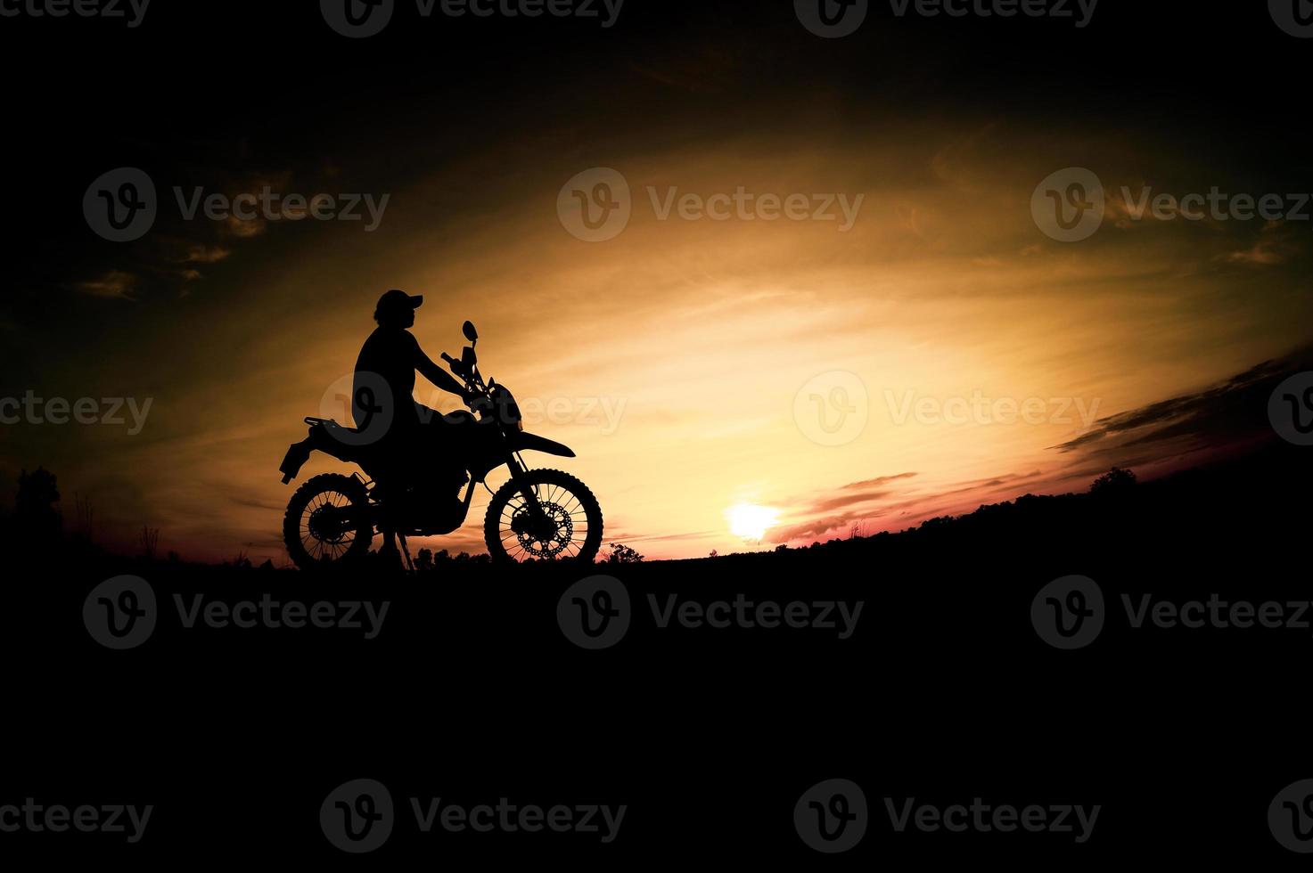 Men's silhouettes and touring motocross bikes. Park to relax in the mountains in the evening. adventure travel and leisure concept photo