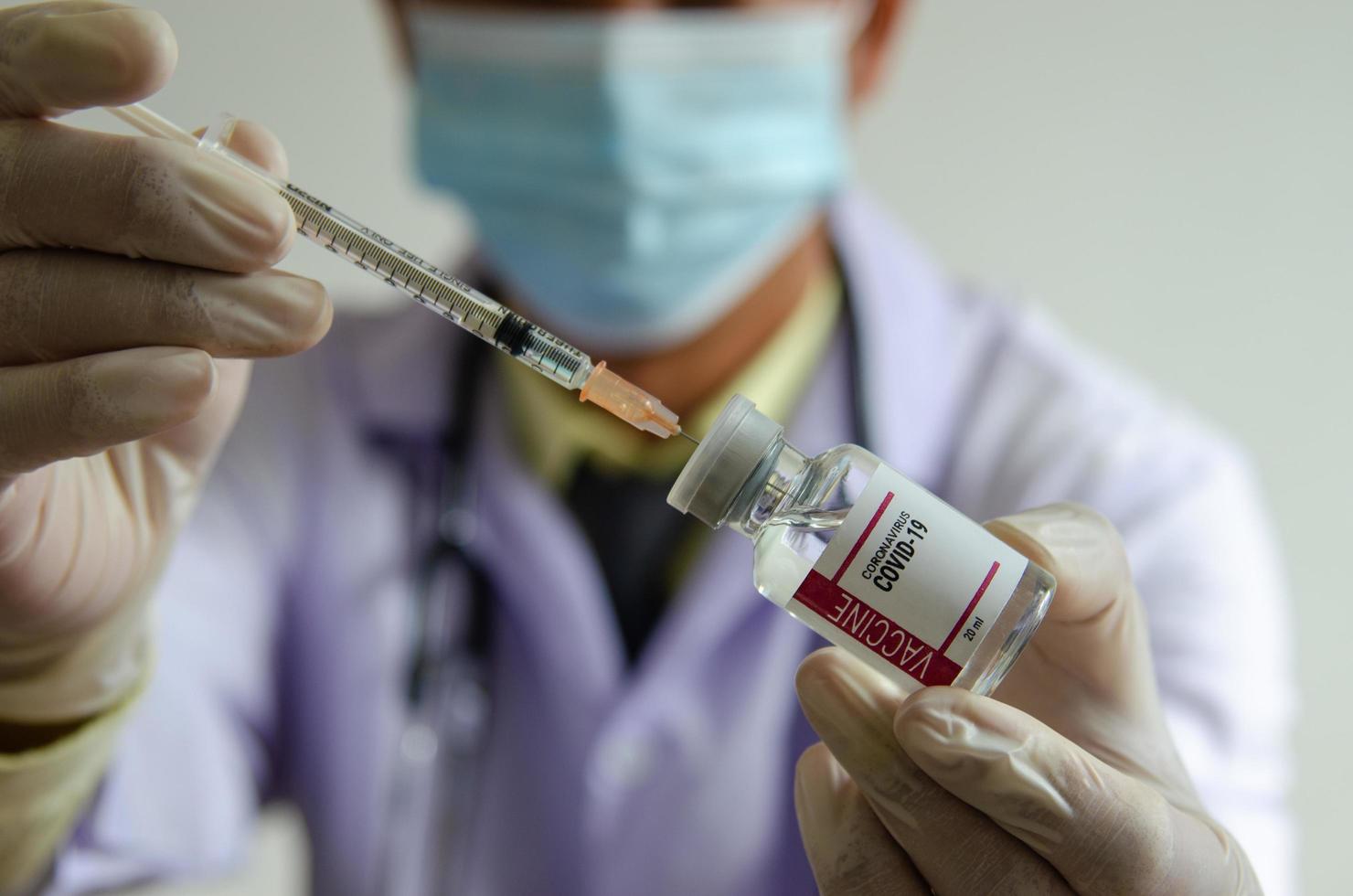 Doctor or scientist holding a bottle of covid vaccine. photo