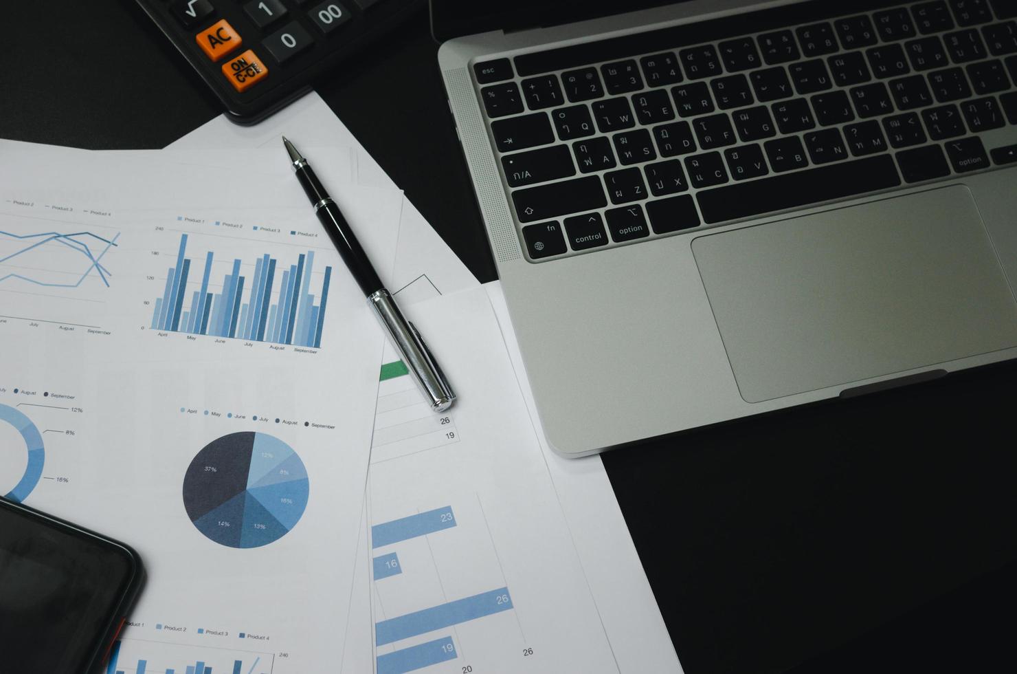 Business document finance graph and chart report analysis marketing and accounting with computer laptop on desk at office. photo