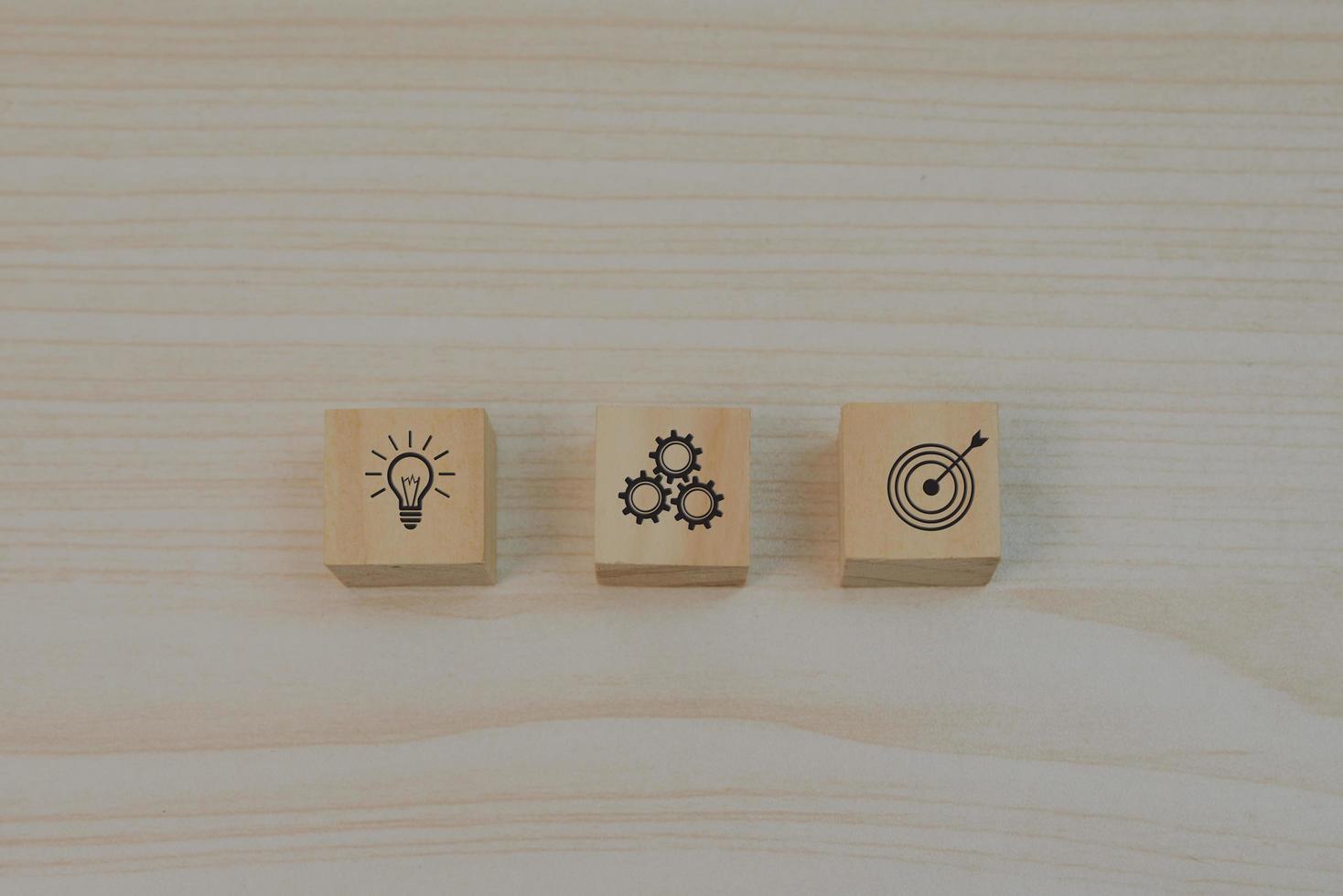 Strategy goals and investment plan business marketing icon symbol gear and light bulb with wood block cube on table. photo