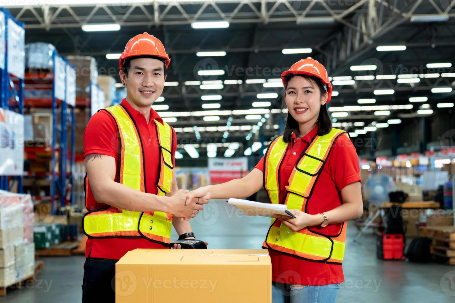 Male and female staff workers shaking hands with deals in warehouse, success collaboration concept, teamwork. photo