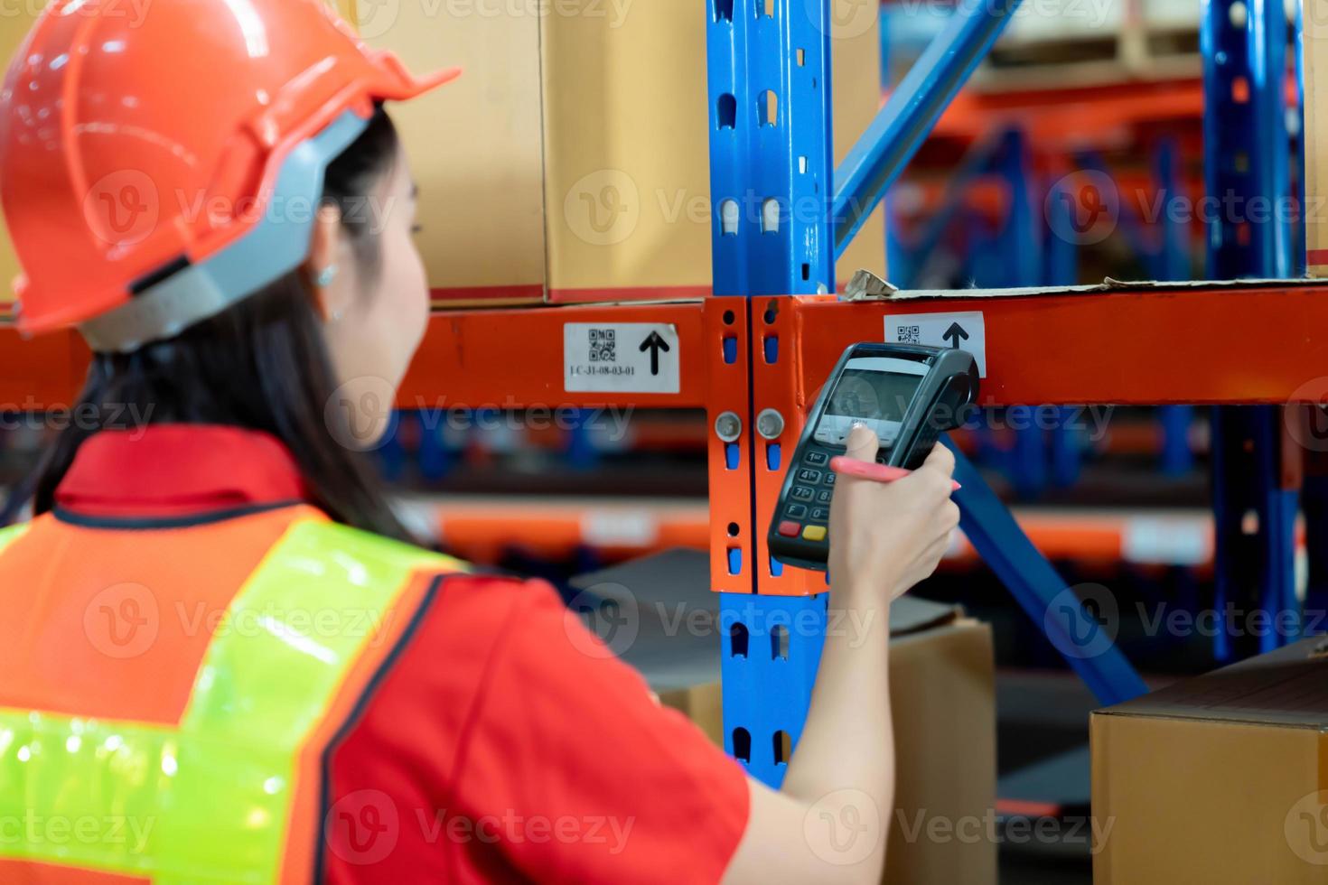Closeup shot of worker scanning  barcode reader. Reading and Scanning labels on the boxes with bluetooth barcode scanner in a warehouse. photo