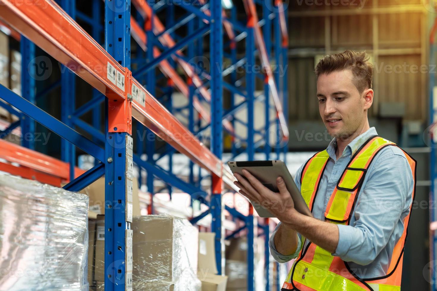 Professional male Worker Checking Stock and Inventory with Digital Tablet Computer in the Retail Warehouse full of Shelves with Goods. Working in Logistics, Distribution Center photo