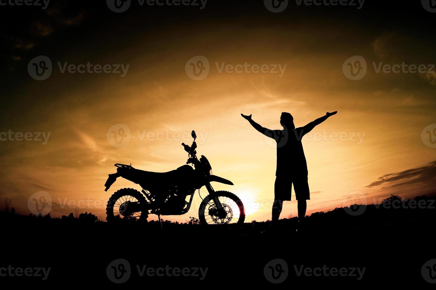 Men's silhouettes and touring motocross bikes. Park to relax in the mountains in the evening. adventure travel and leisure concept photo