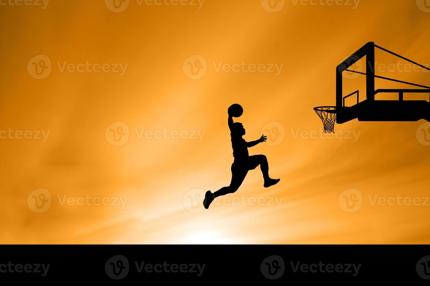 basketball player silhouette jumping photo