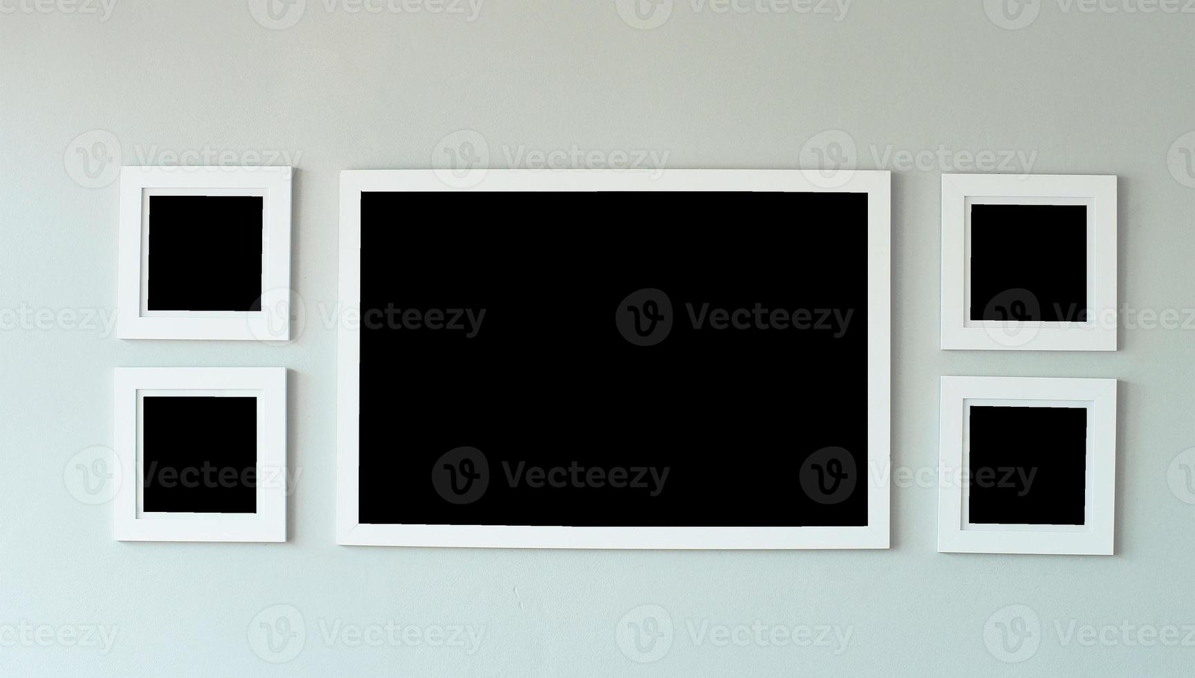 White picture frame on concrete wall with copyspace for inserting desired content. photo