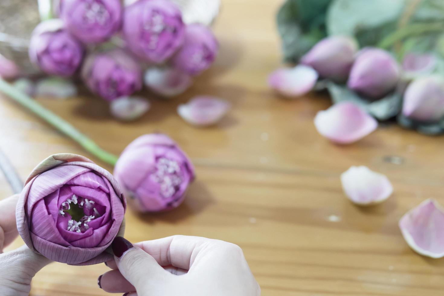 Woman folding pink lotus happily photo