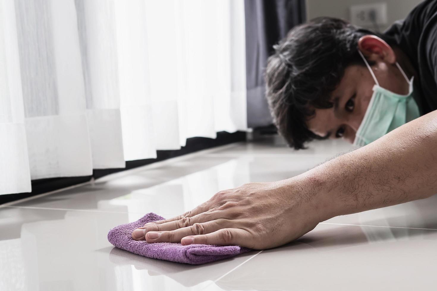 Construction man cleaning tile floor finishing using thinner photo