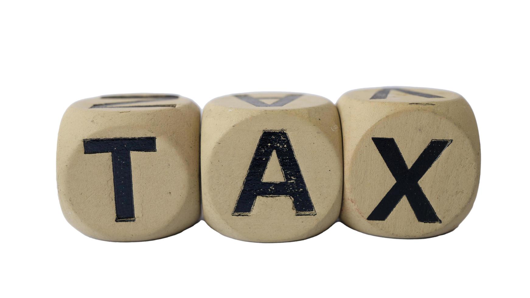 Spelling tax on a piece of wood photo