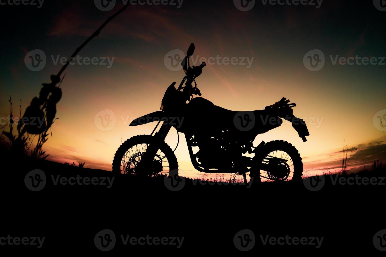 Tourist motorcycle motocross silhouette Park on the mountain in the evening. adventure travel concept photo