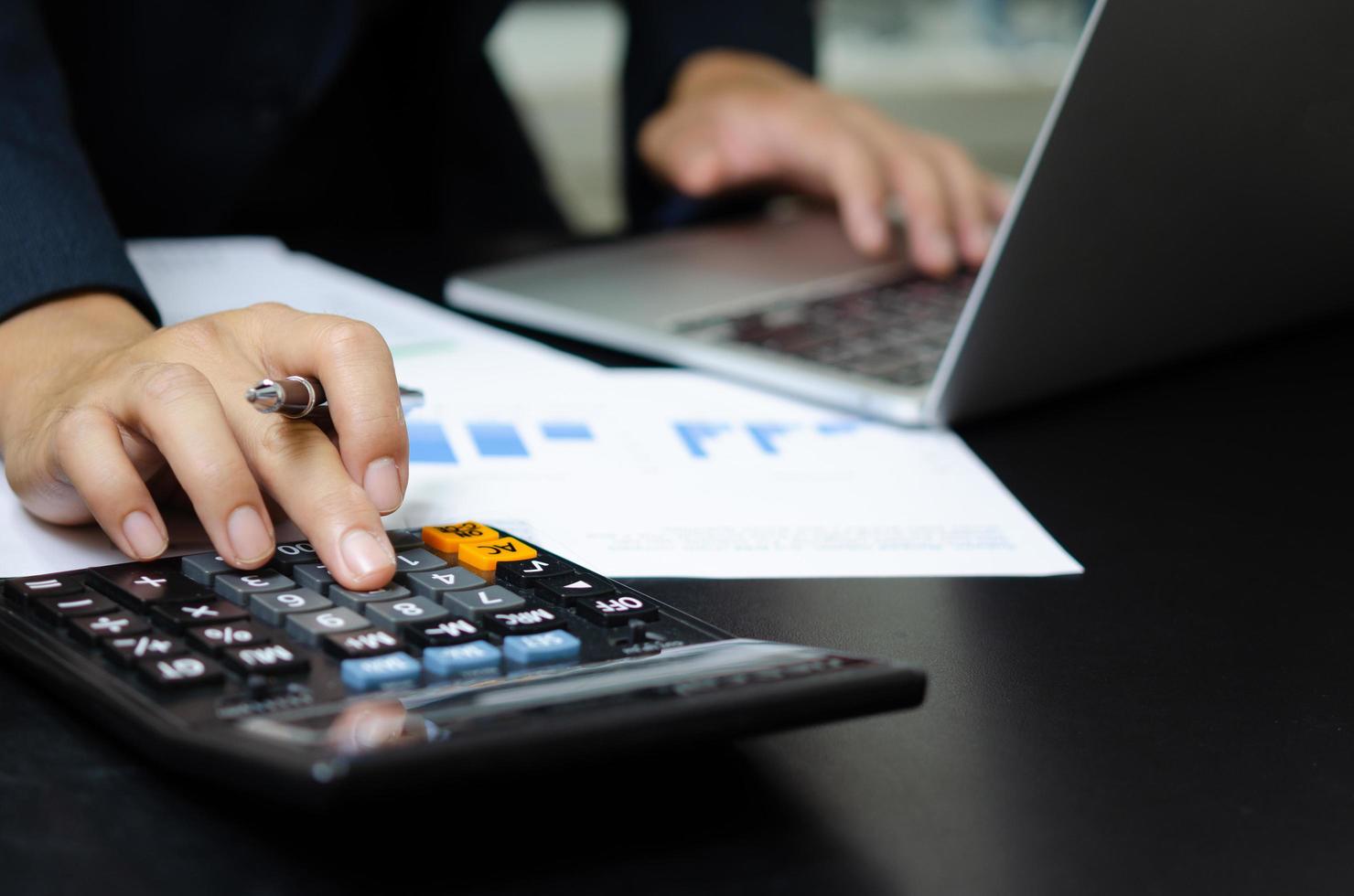 Business document finance report and accounting analysis graph.Businessman using calculate marketing investment chart paperwork statistic on desk. photo