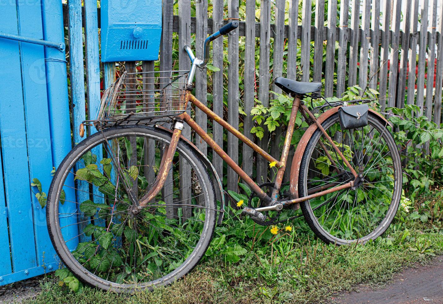 old bike by the wooden fence photo