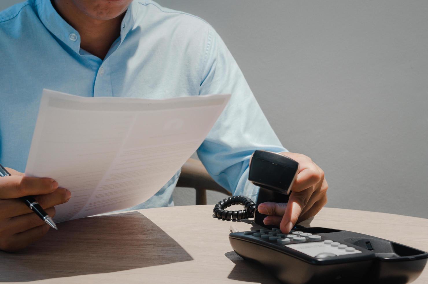 business people use phone and hold business documents for big data analysis marketing planning. photo
