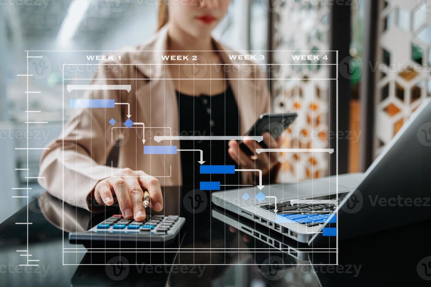 Project manager working and update tasks with milestones progress planning and Gantt chart scheduling diagram. business working with smart phone, tablet and laptop in office. photo