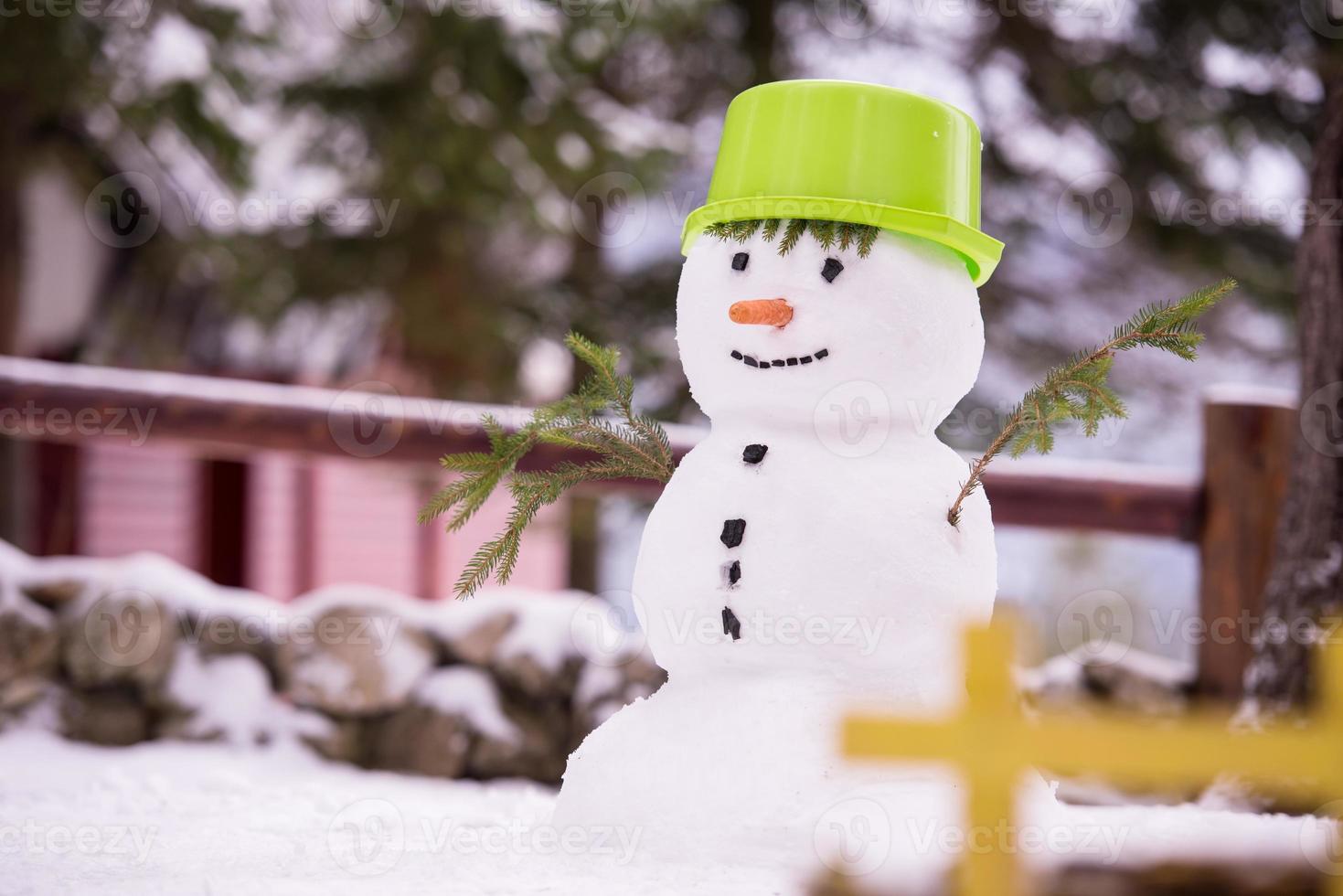 muñeco de nieve sonriente con sombrero verde foto