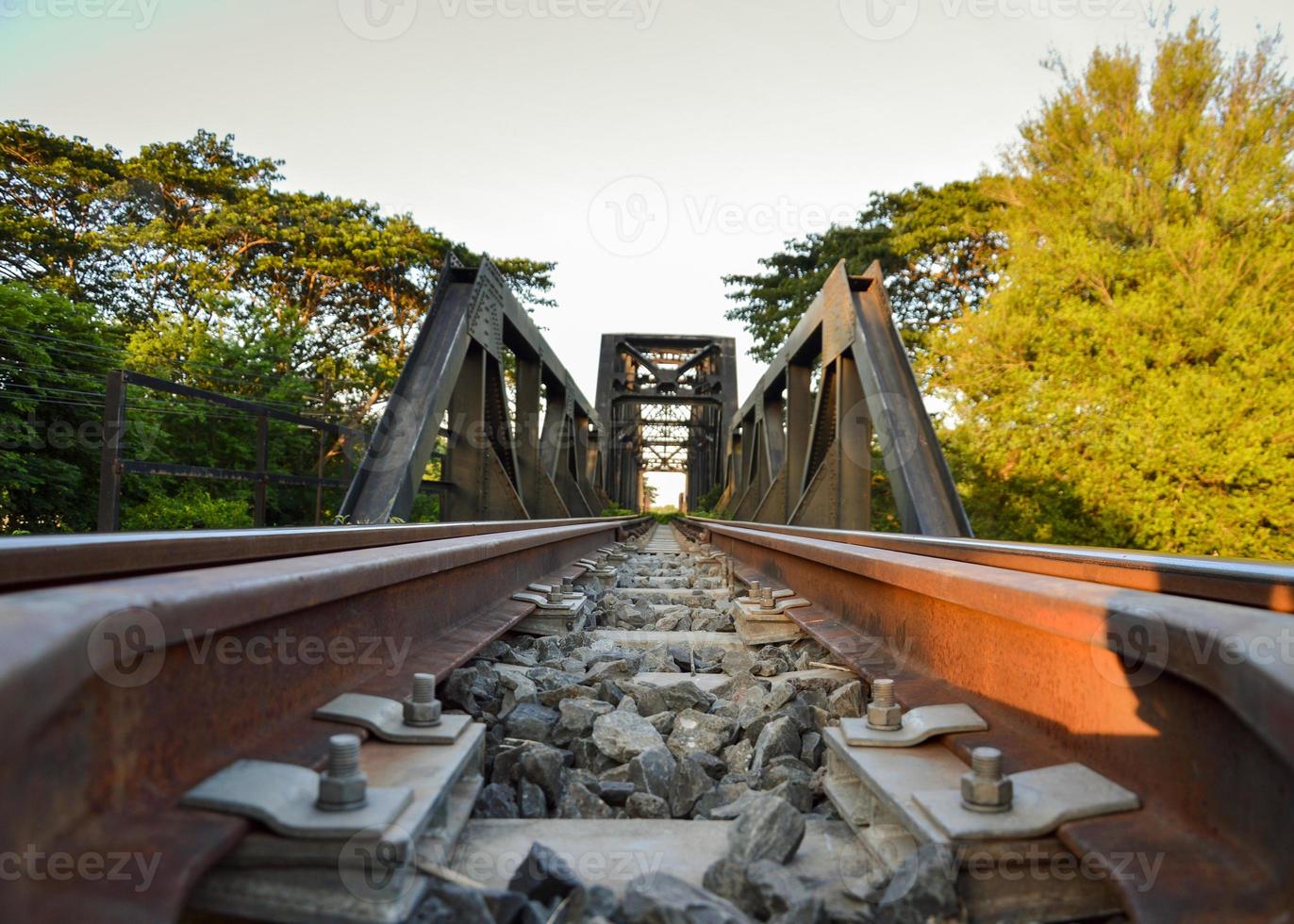 Gray screw nut fixing the railroad lock with brown rust.  Steel structure concept, strong and durable photo