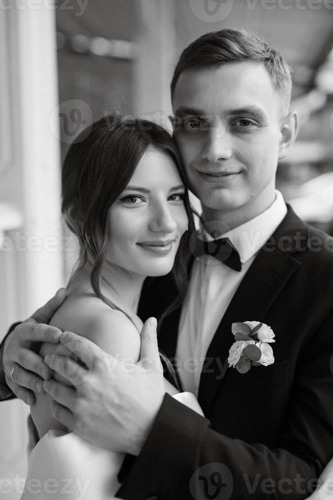 young couple bride and groom in a white short dress photo