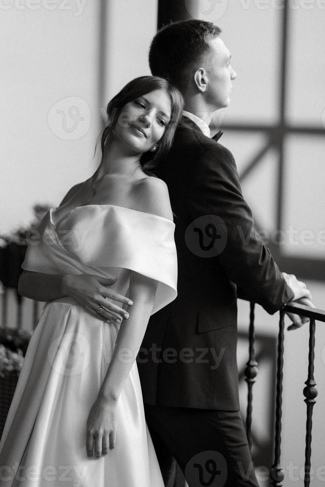 young couple bride and groom in a white short dress photo