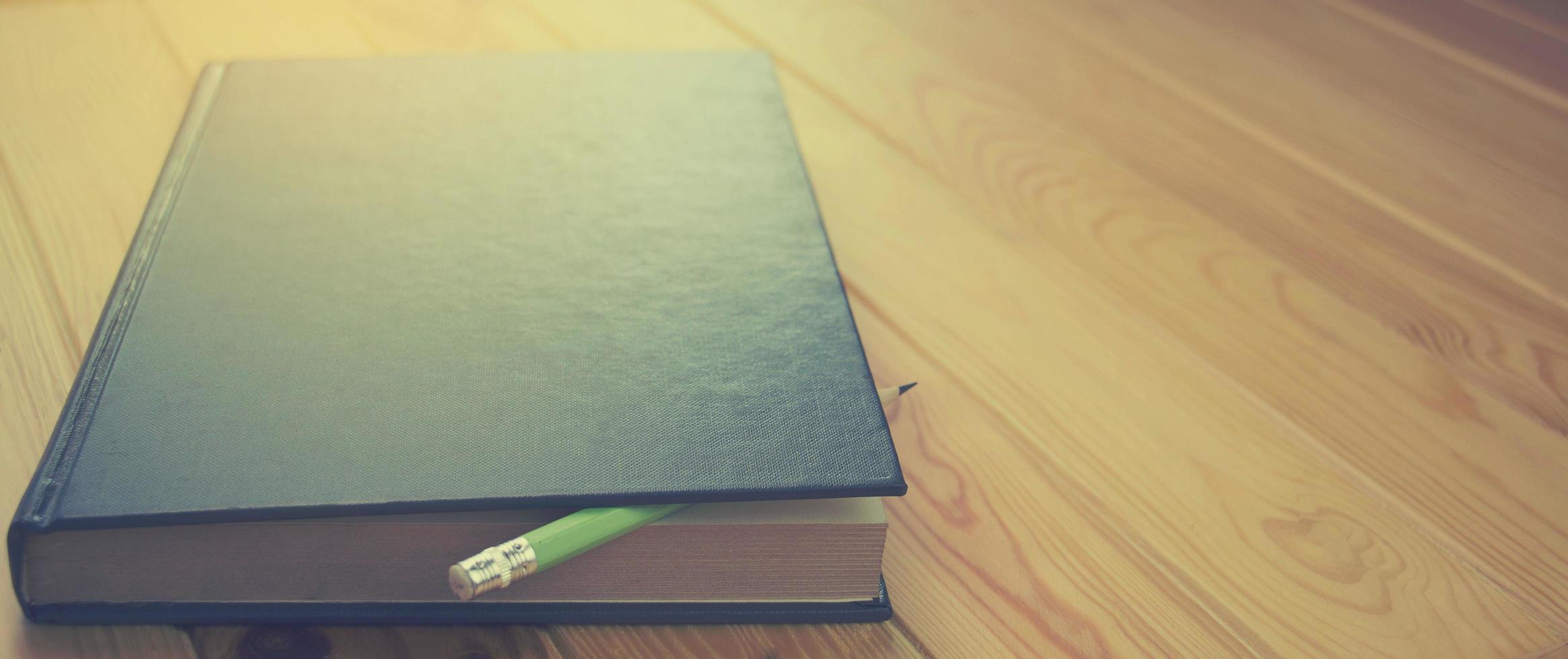 dark blue book on brown wooden table photo