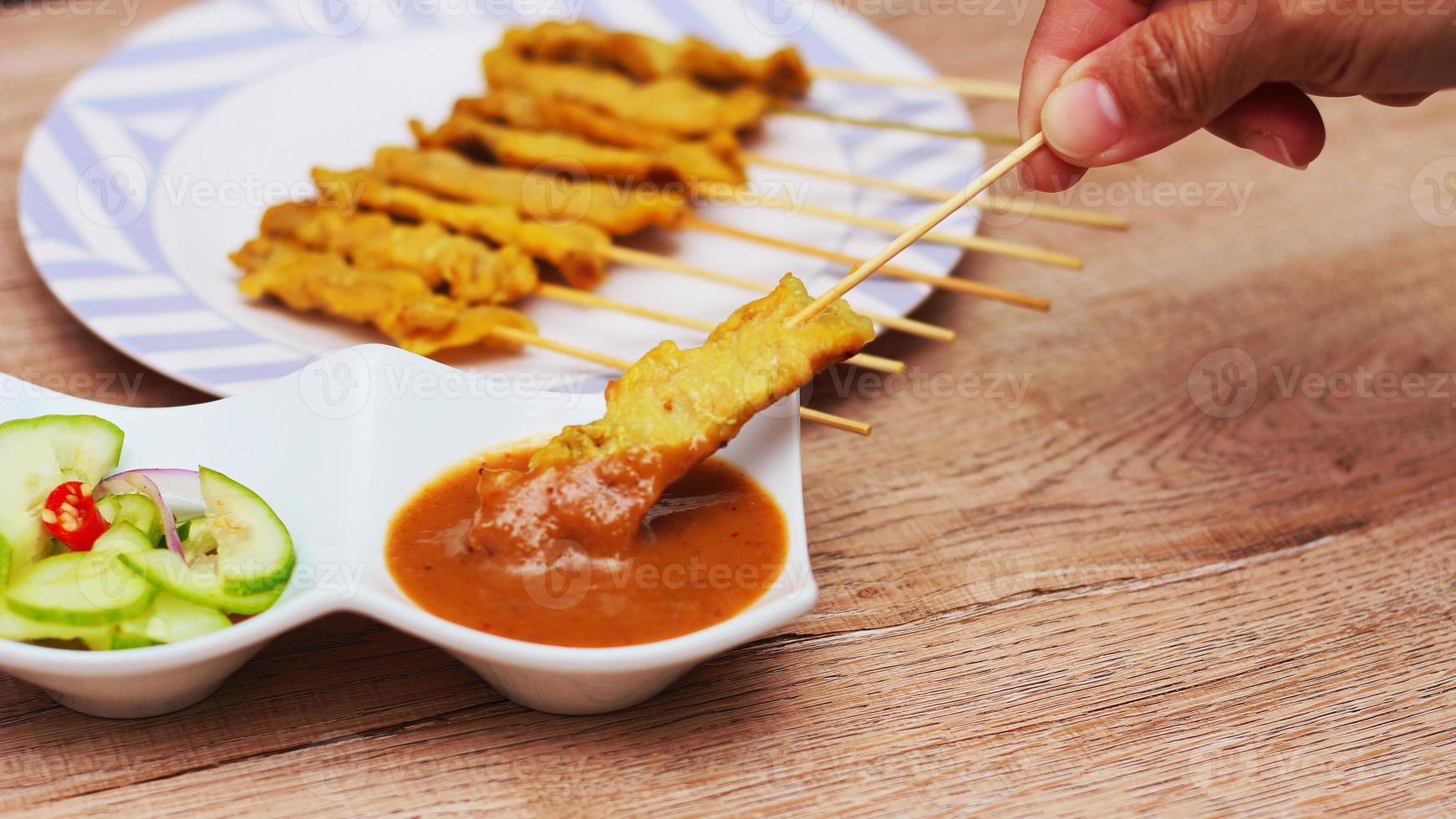 Pork satay,Grilled pork served with peanut sauce or sweet and sour sauce, Thai Street food. photo