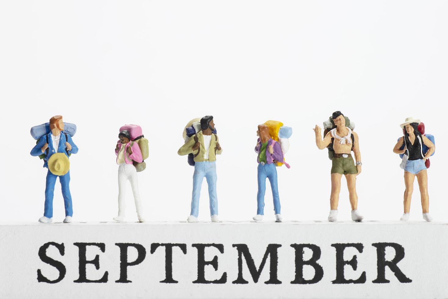Small traveller figure for World Tourism Day background - September 27, UNWTO World Tourism Day celebration concept photo