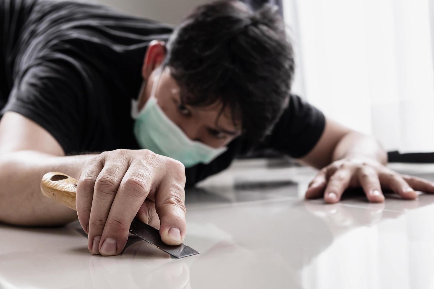 Construction man cleaning tile floor finishing using thinner photo