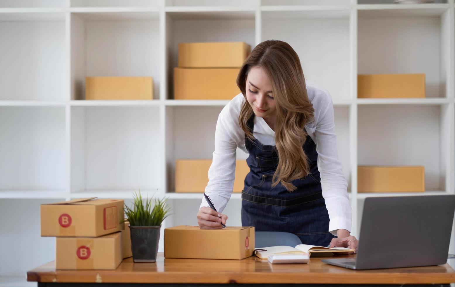 Portrait of Starting small businesses SME owners female entrepreneurs working on receipt box and check online orders to prepare to pack the boxes, sell to customers, sme business ideas online. photo