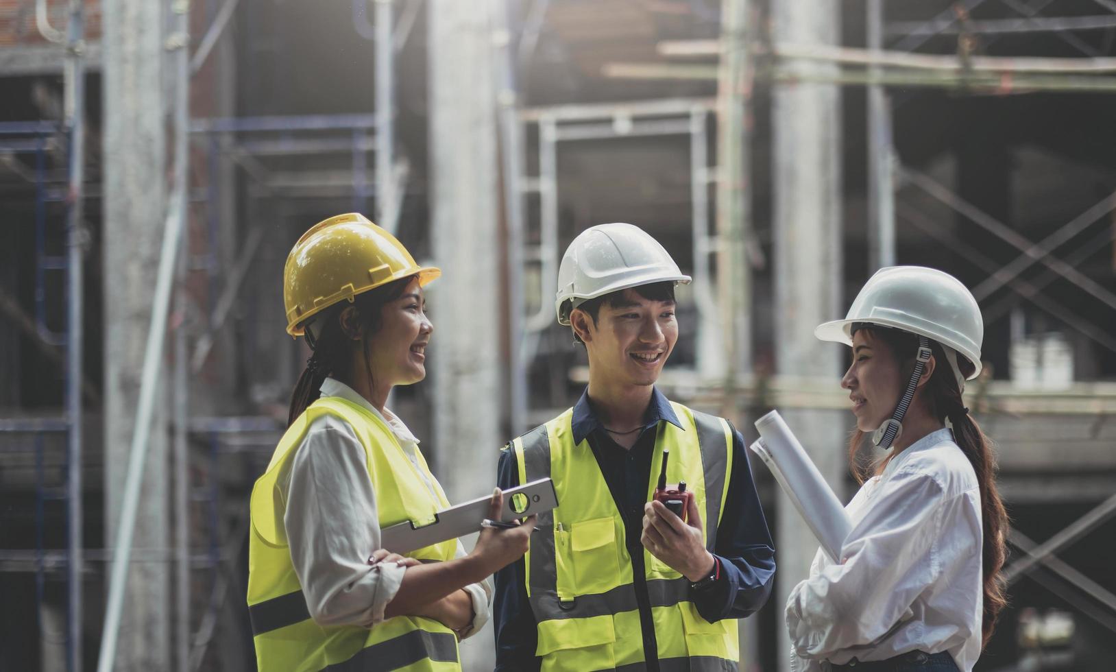 Professional Construction and Engineer team Working on workplace. Professional black architect and construction worker working look at blueprint plan on site. photo