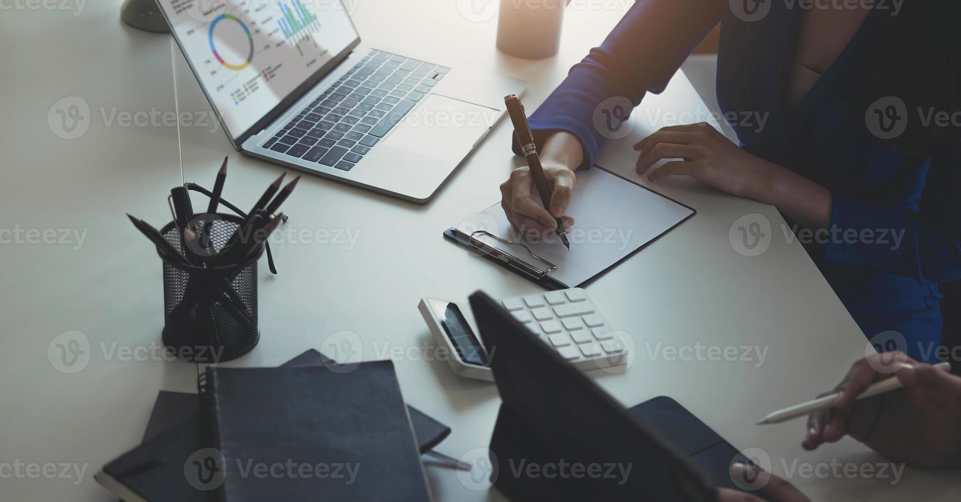 Close up of Business team analyzing income charts and graphs with modern laptop computer. Business analysis and strategy concept. photo