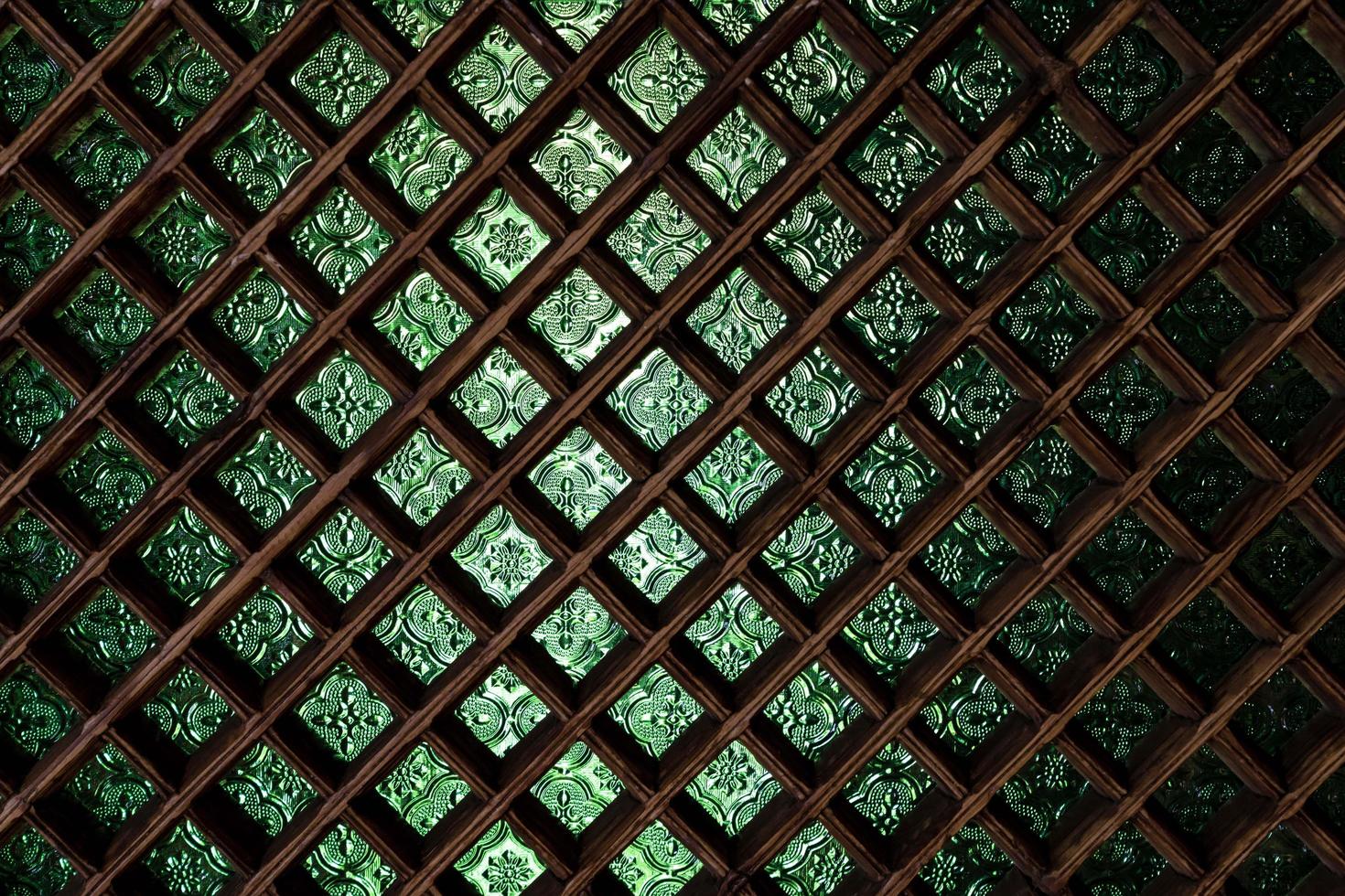 green stained glass window with wooden grid photo