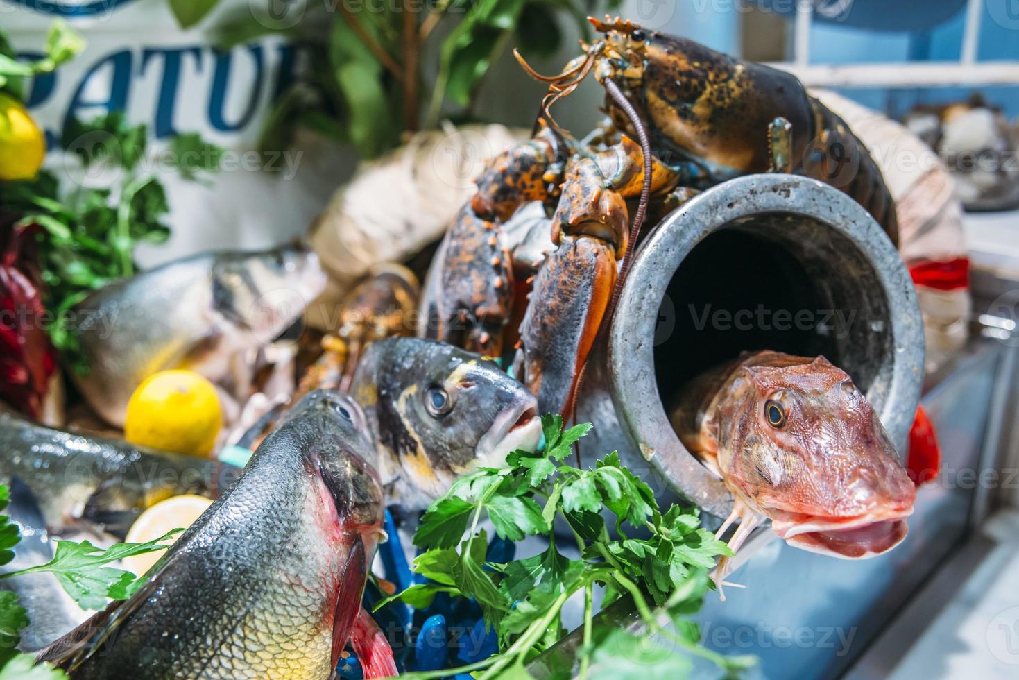 Seafood platter with a variety of types of fish on display on ice at a restaurant photo