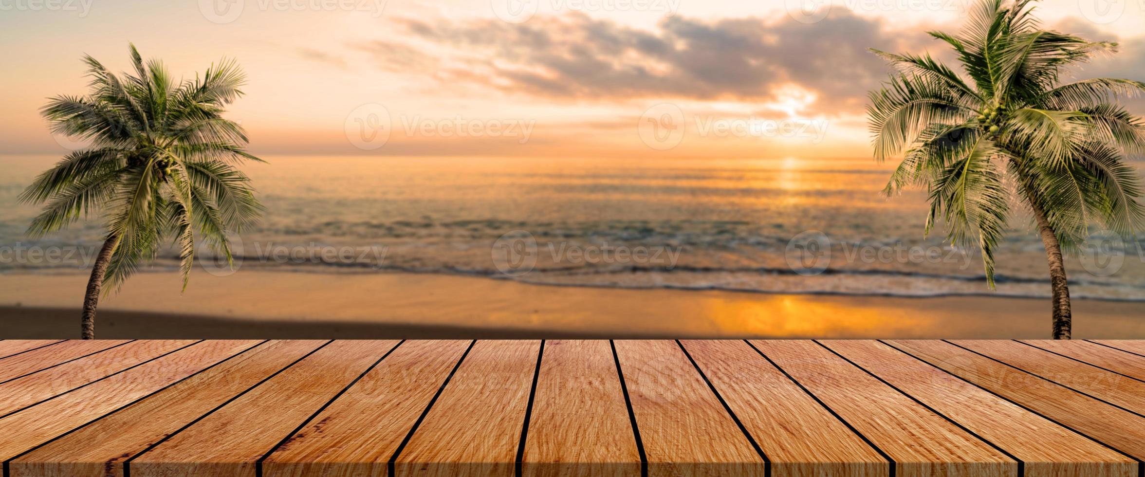 long wooden table with beach landscape blur background photo