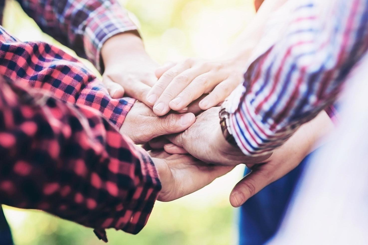 People group join hands together as teamwork unity symbol during their meeting activity to achieve their ultimate goal. photo