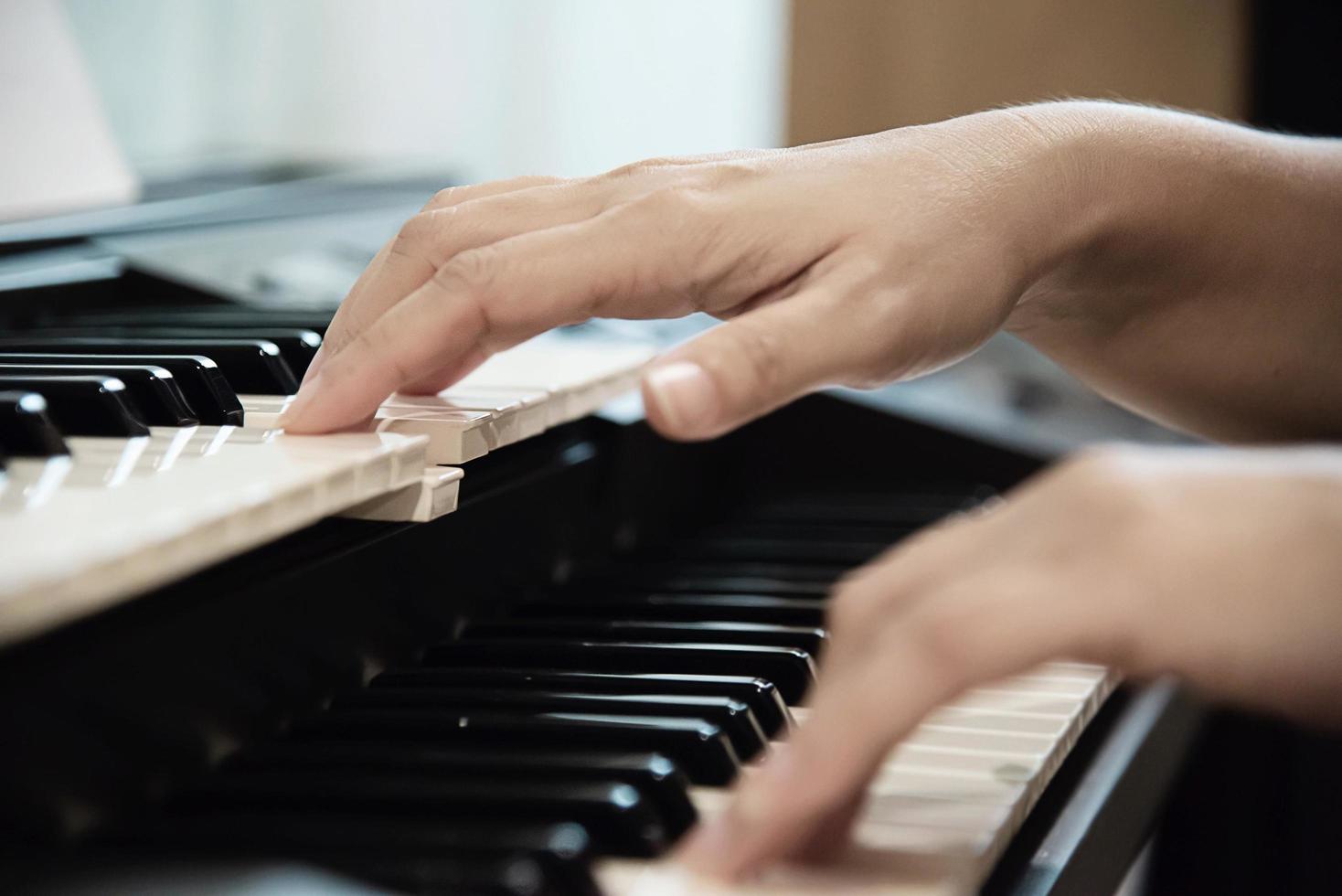 Man hand play electone keyboard - people with music concept photo