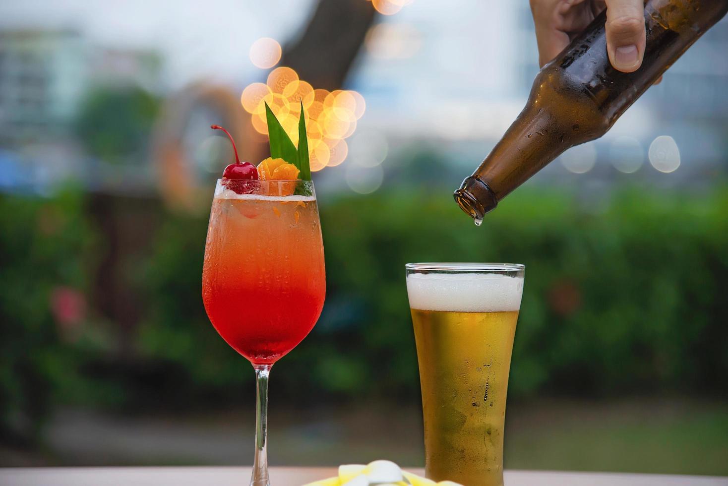 People celebration in restaurant with beer and mai tai or mai thai - happy lifestyle people with happy drink in garden concept photo