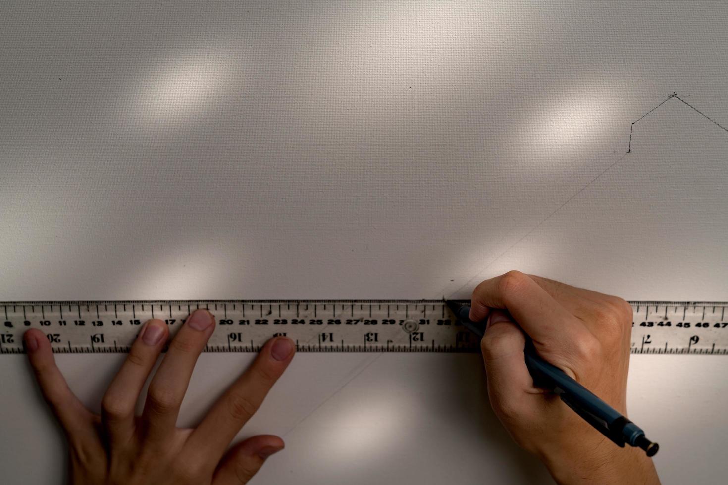 hand holding ruler and clutch-type pencil with canvas background photo