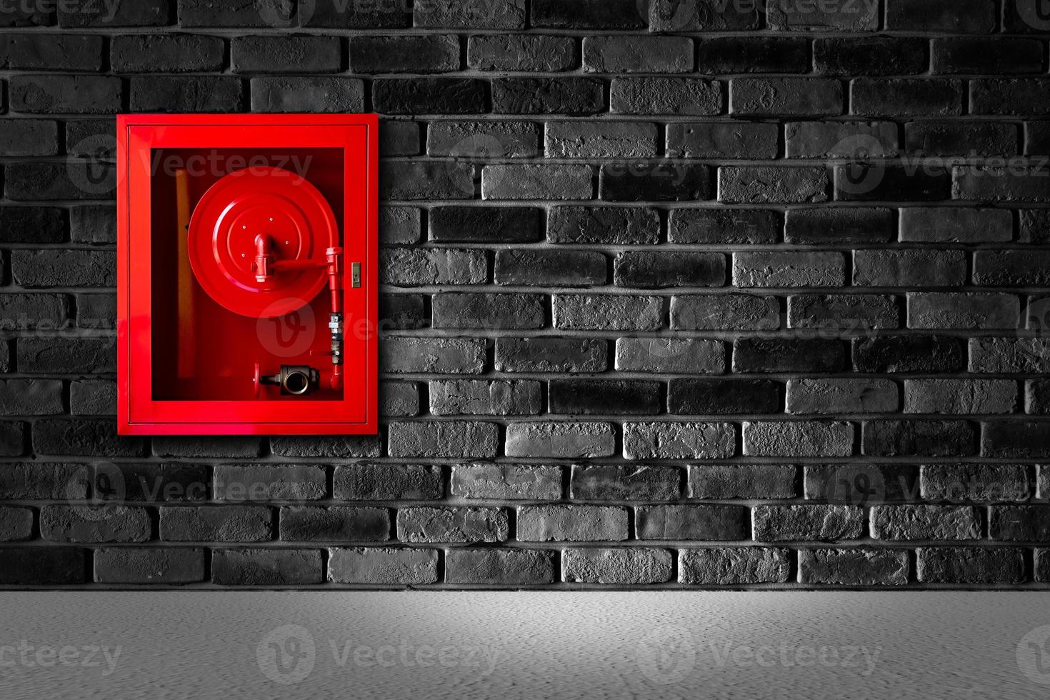 fire extinguish equipment with black brick wall photo