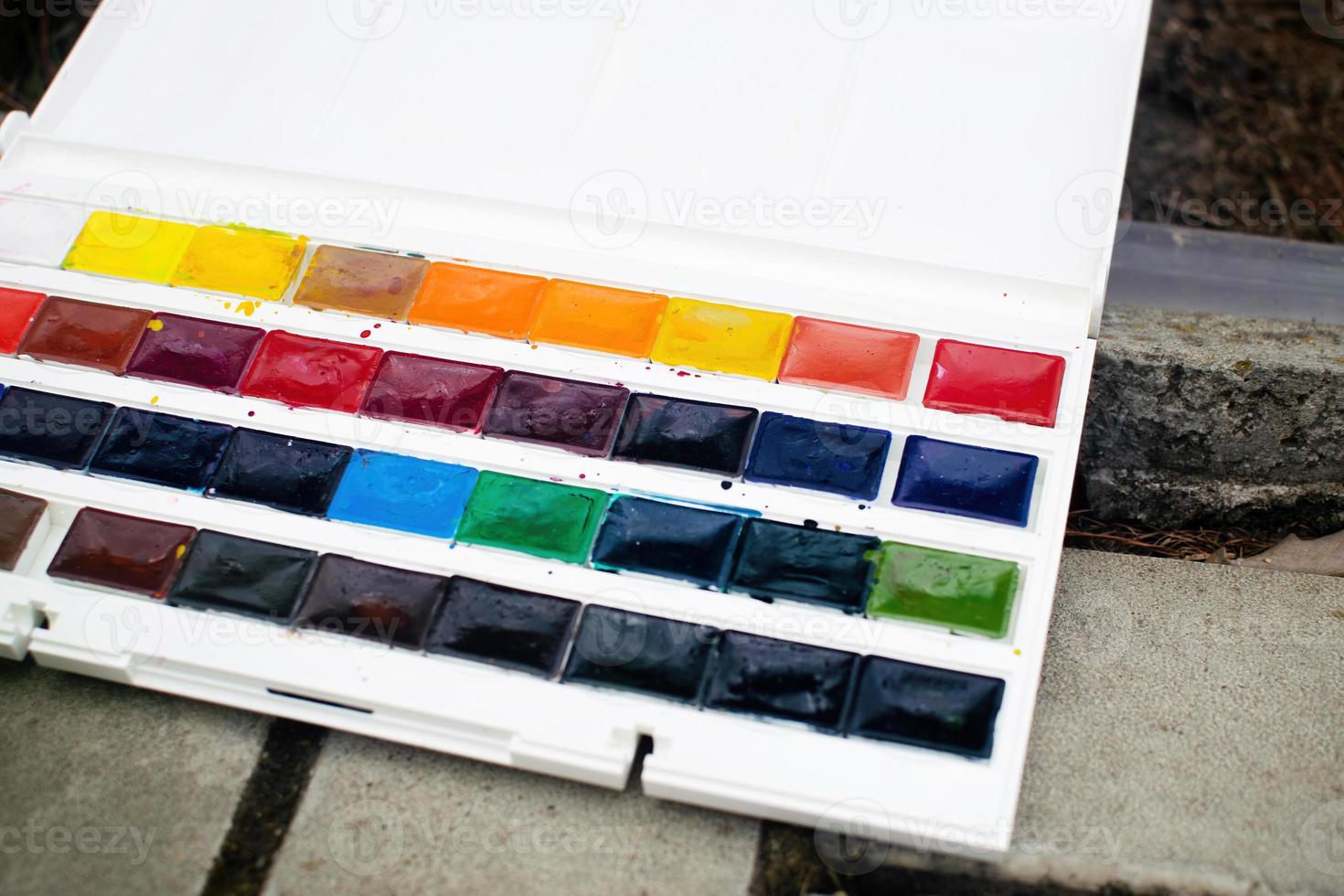 Set of watercolor paints. Watercolor for sketching in nature. photo