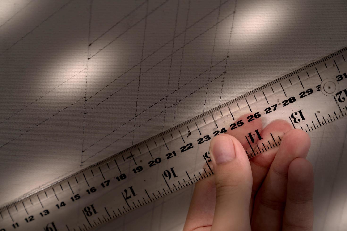 hand holding ruler with canvas background photo