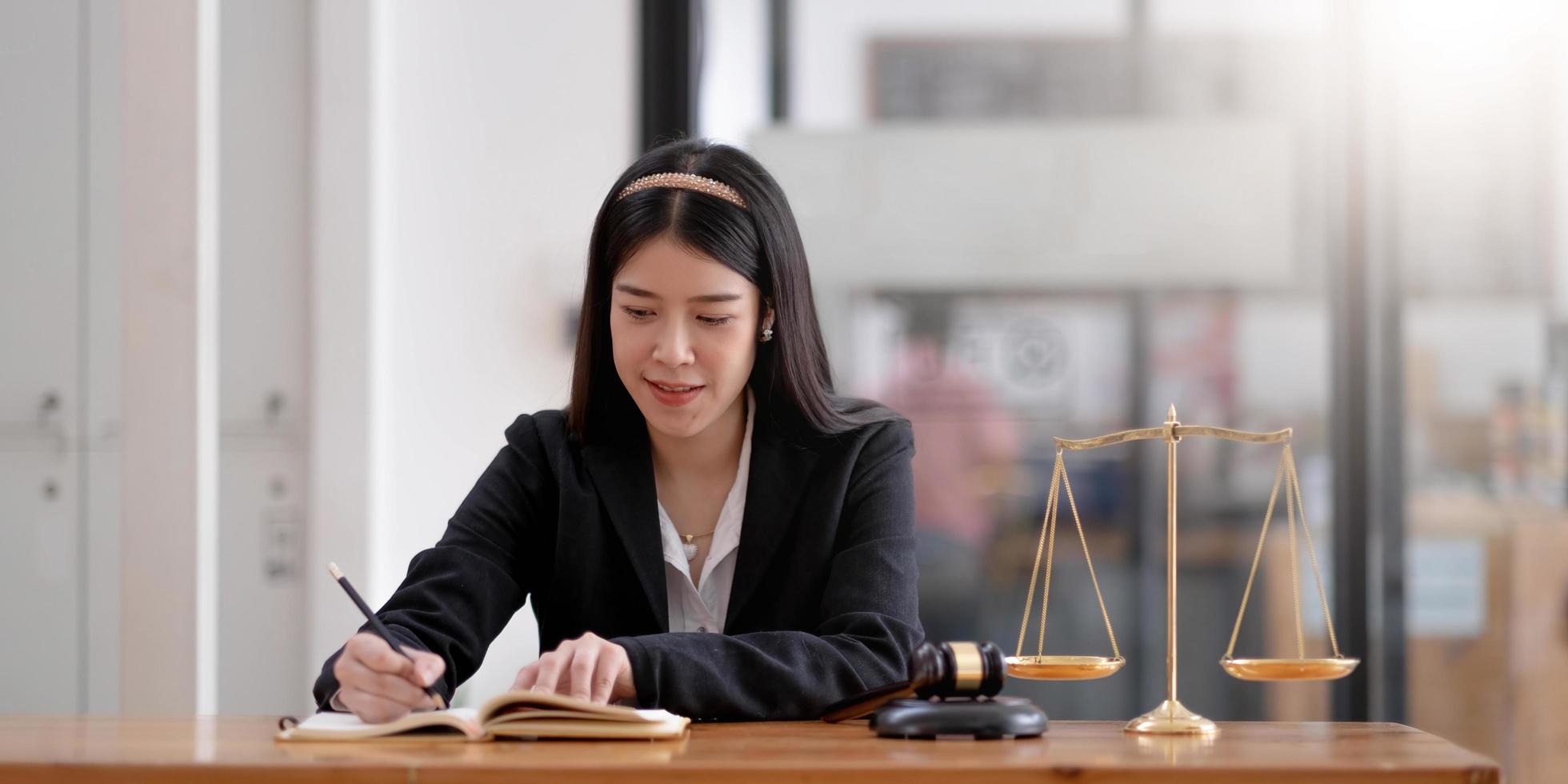 Business and lawyers discussing contract papers with brass scale on desk in office. Law, legal services, advice, justice and law concept photo