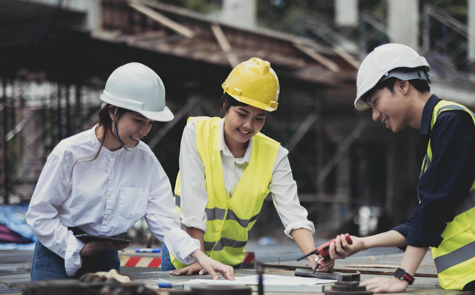Three experts inspect commercial building construction sites, industrial buildings real estate projects with civil engineers, investors use laptops in background home, concrete formwork framing. photo
