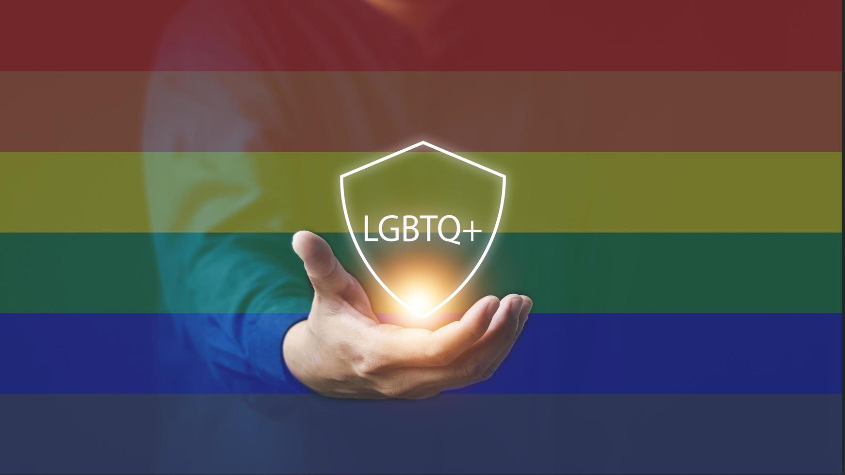 The concept of LGBTI people or LGBTQ queer men's hands with rainbow flags and messages LGBTQ to express acceptance from family and society photo