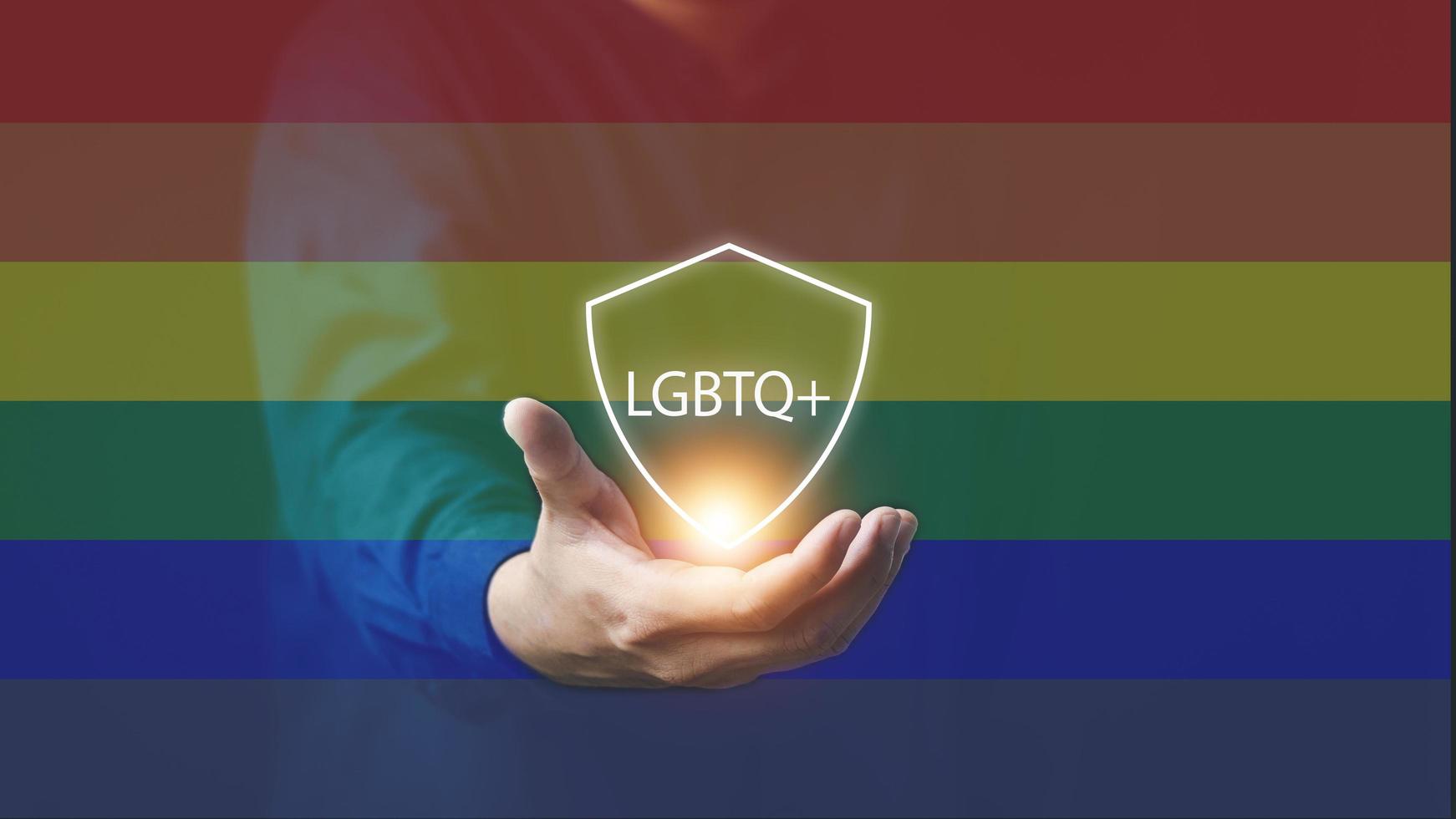 The concept of LGBTI people or LGBTQ queer men's hands with rainbow flags and messages LGBTQ to express acceptance from family and society photo
