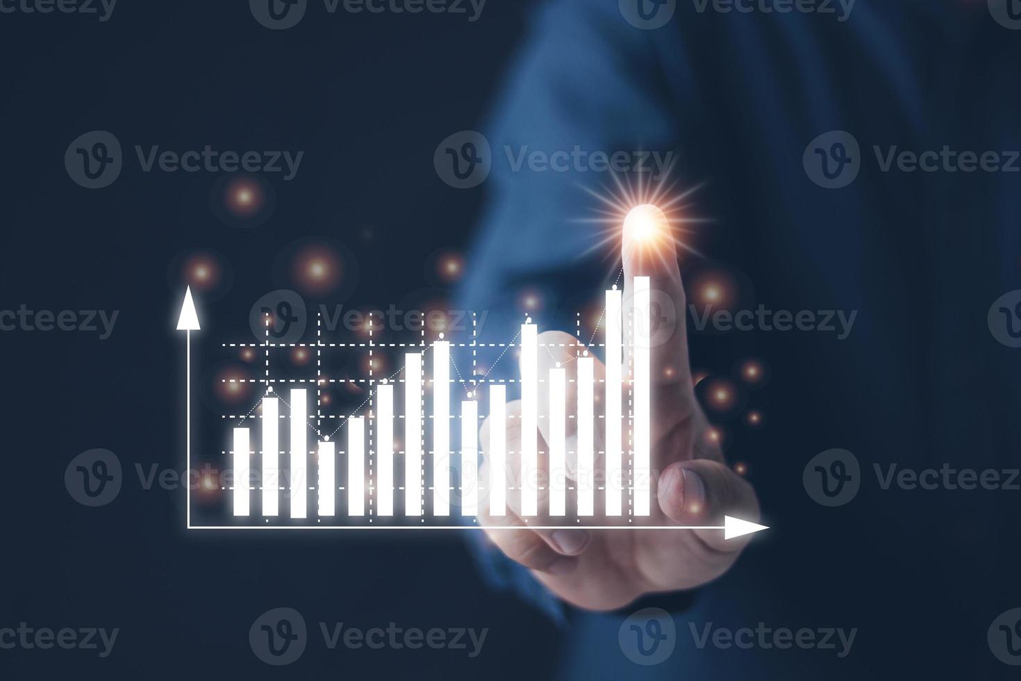 financial and investment technology concept men's hands are active to plan stock chart analysis to invest in financial markets. The other hand has a virtual image as a candlestick chart. photo