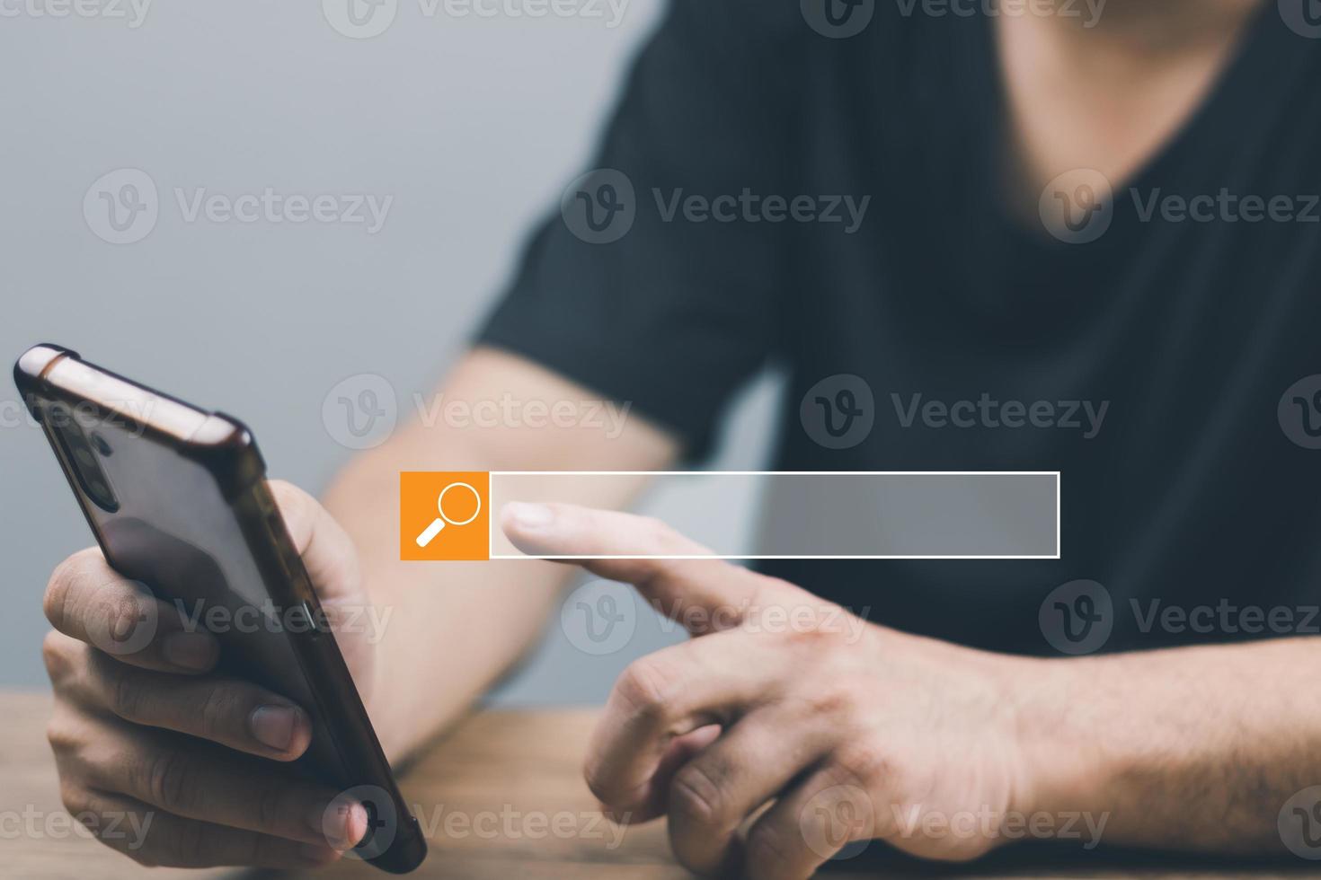 The concept of using technology to search for information, a man's hand is using a smartphone to search for information on social media via the Internet online. photo